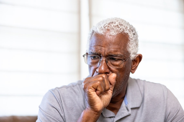 man-coughing-into-hand